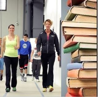Picture of people walking indoors next to a stack of books