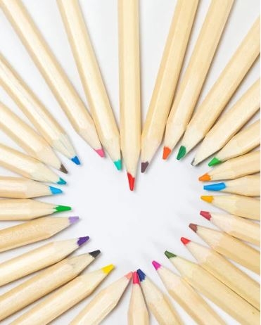 photo of a bunch of colored pencils with their tips shaping a heart