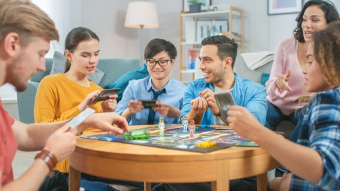 Image of young adults playing a board game