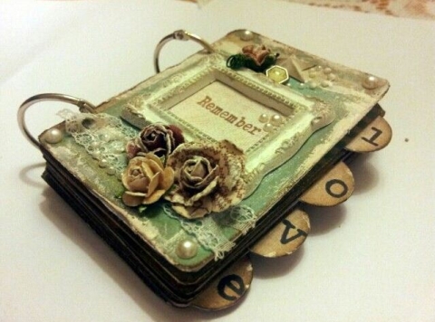 A mini book decorated and held together with binder rings
